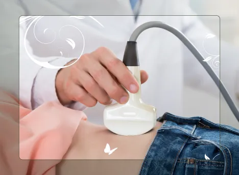 Doctor performing 3D & 4D Scans using an ultrasound probe on a pregnant patient's belly.